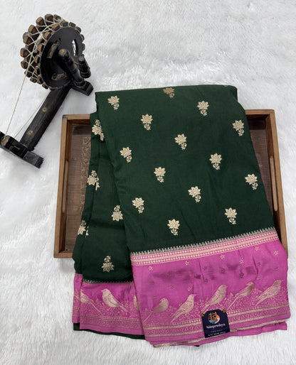 Banarasi Fancy Saree Bottle Green Colored Complemented with a Pink Zari Border.
