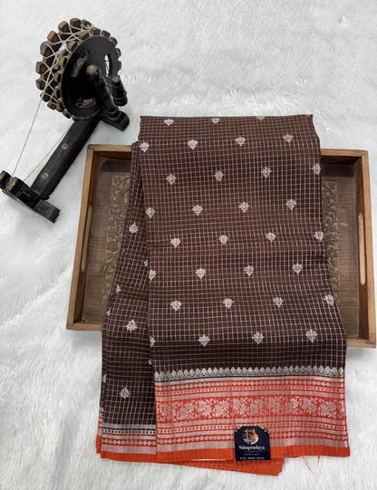 Banarasi Fancy Saree Brown Colored Complemented with a Orange Zari Border.