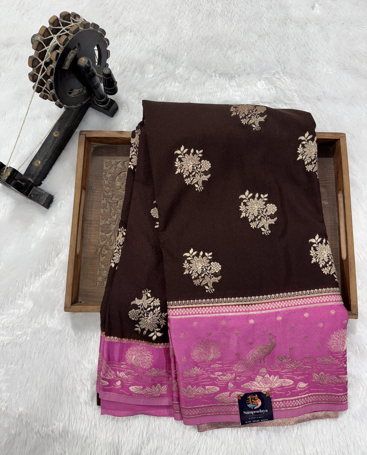 Banarasi Fancy Saree Brown Colored Complemented with a Pink Zari Border.