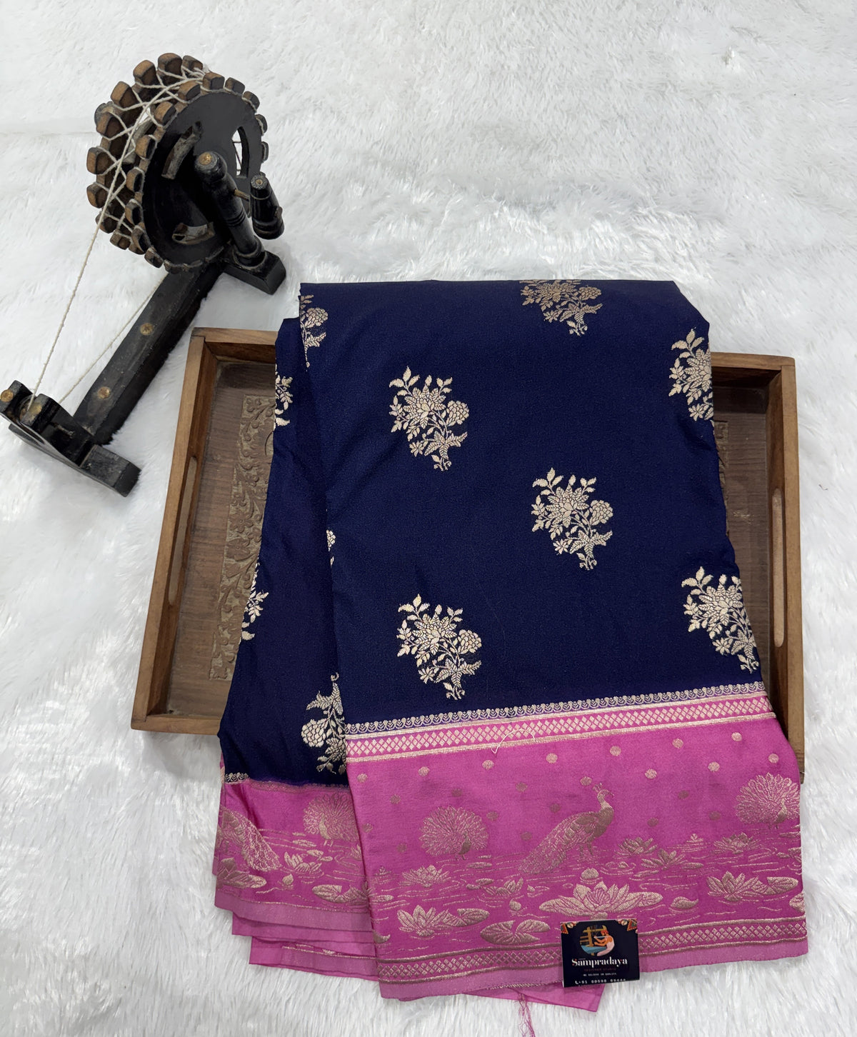 Banarasi Fancy Saree Navy Blue Colored Complemented with a Pink Zari Border.