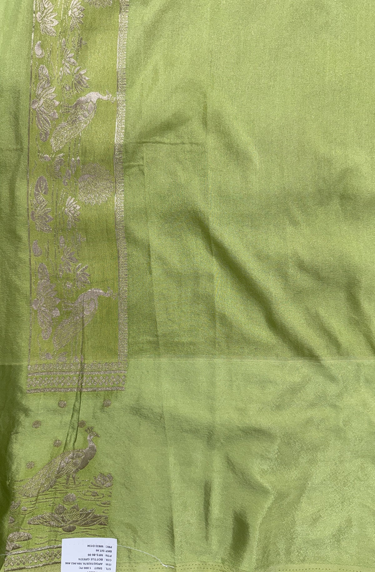 Banarasi Fancy Saree Bottle Green Colored Complemented with a Light Green Zari Border.