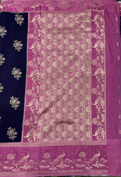 Banarasi Fancy Saree Navy Blue Colored Complemented with a Pink Zari Border.