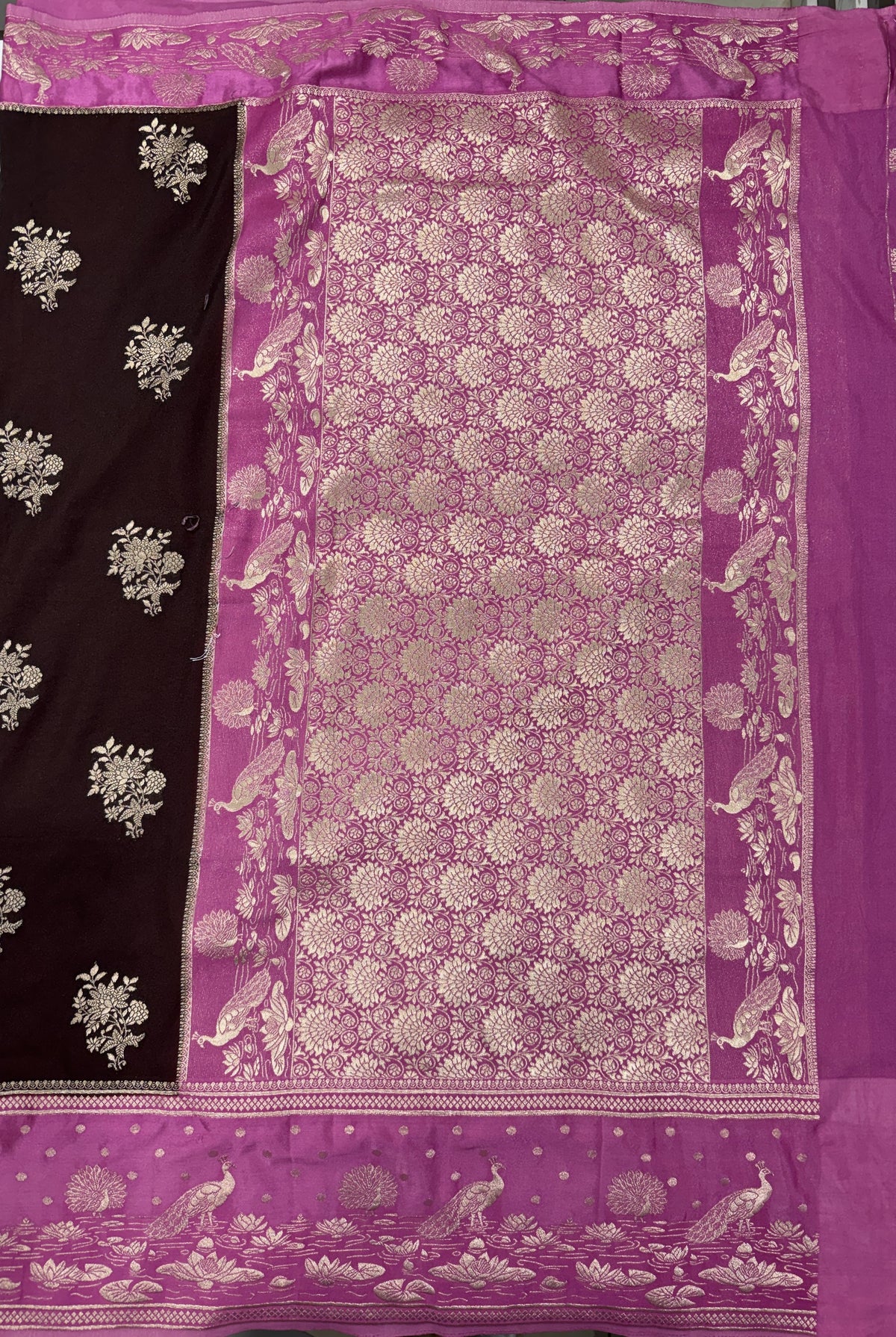 Banarasi Fancy Saree Brown Colored Complemented with a Pink Zari Border.
