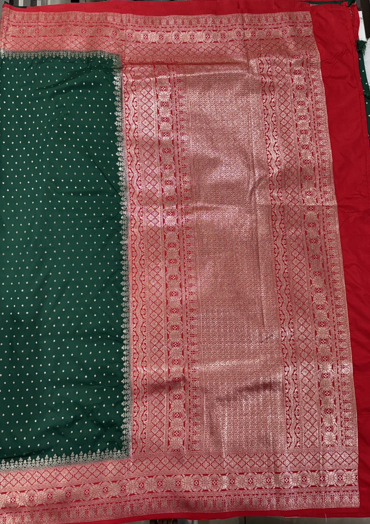 Banarasi Fancy Saree Bottle Green Colored Complemented with a Red Zari Border.