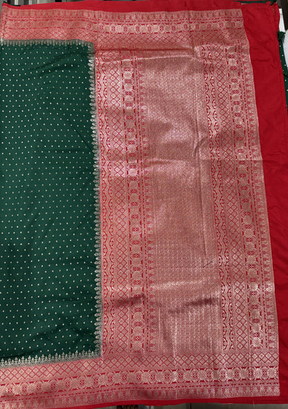 Banarasi Fancy Saree Bottle Green Colored Complemented with a Red Zari Border.