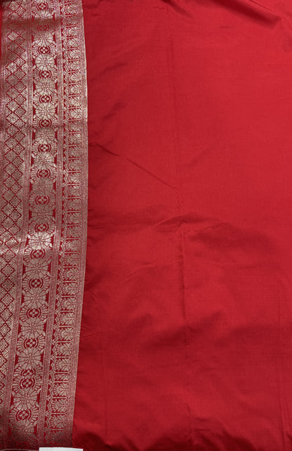 Banarasi Fancy Saree Bottle Green Colored Complemented with a Red Zari Border.