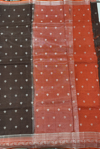 Banarasi Fancy Saree Brown Colored Complemented with a Orange Zari Border.