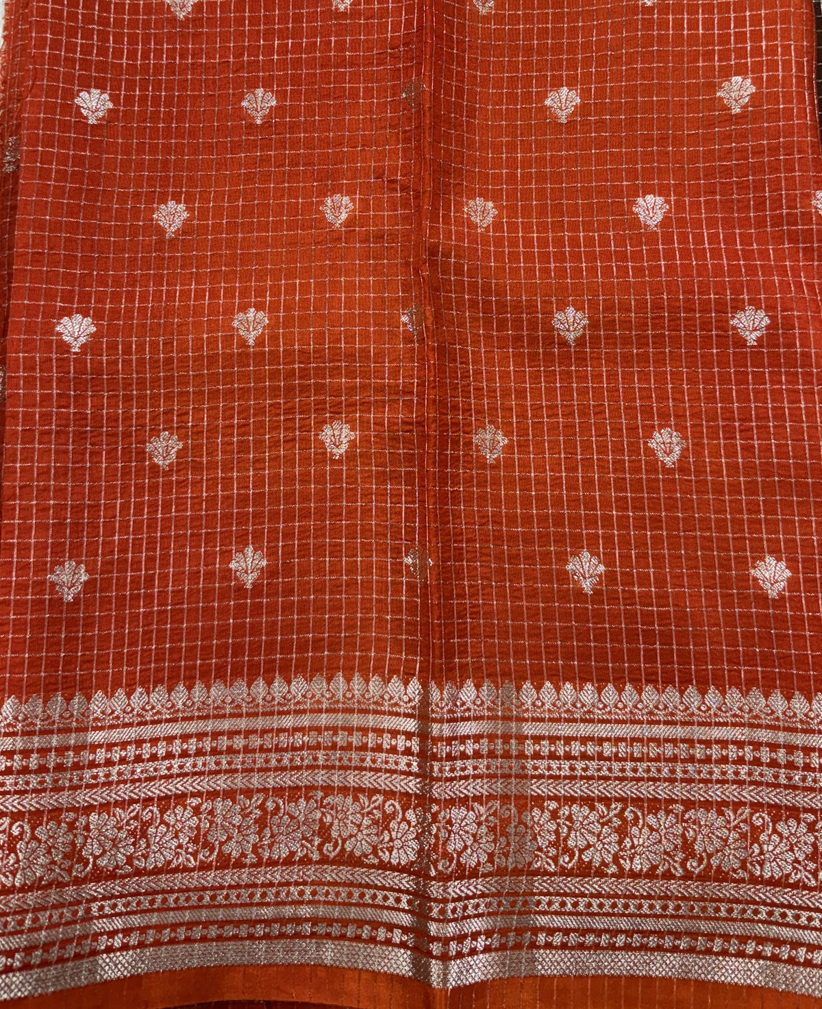 Banarasi Fancy Saree Brown Colored Complemented with a Orange Zari Border.