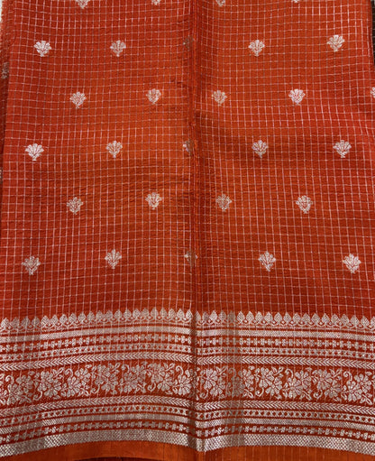 Banarasi Fancy Saree Brown Colored Complemented with a Orange Zari Border.