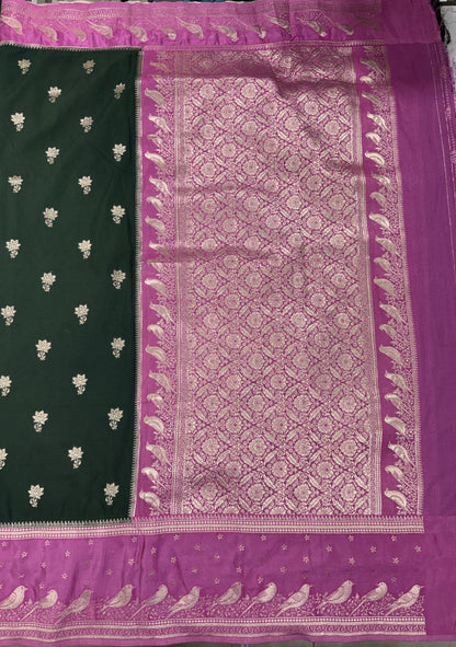 Banarasi Fancy Saree Bottle Green Colored Complemented with a Pink Zari Border.