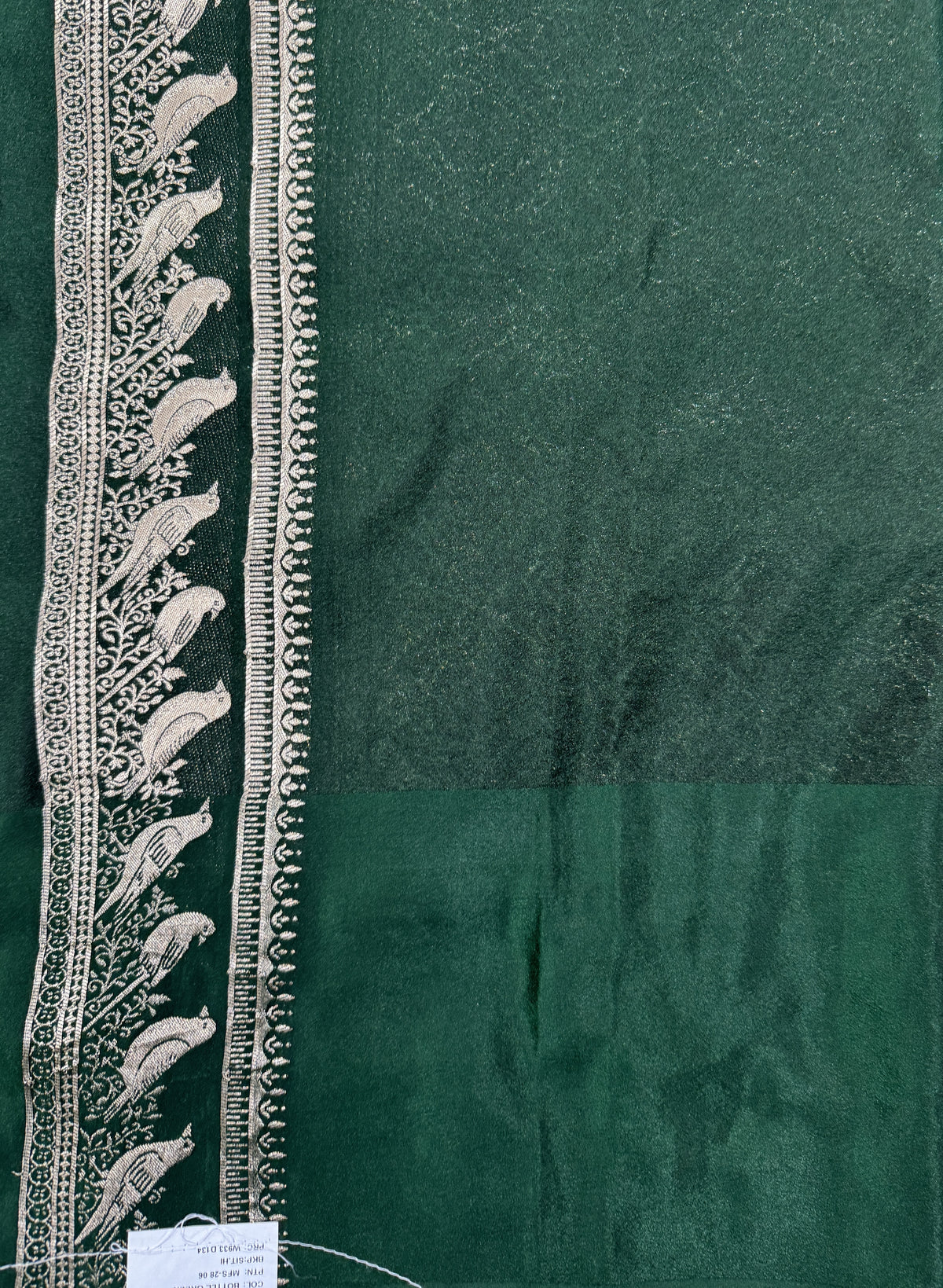 Banarasi Fancy Saree Bottle Green Colored Complemented with a Pink Zari Border.