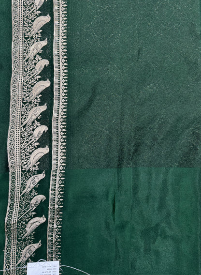 Banarasi Fancy Saree Bottle Green Colored Complemented with a Pink Zari Border.