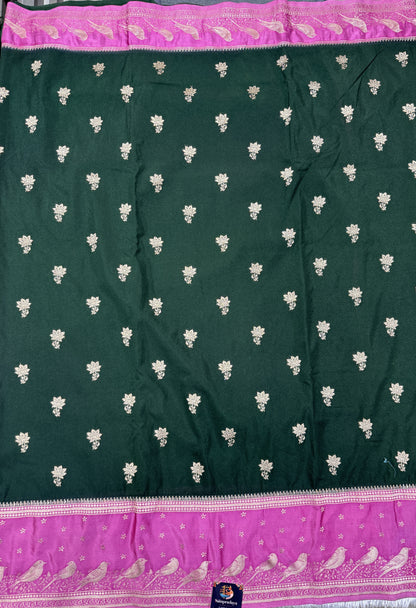Banarasi Fancy Saree Bottle Green Colored Complemented with a Pink Zari Border.