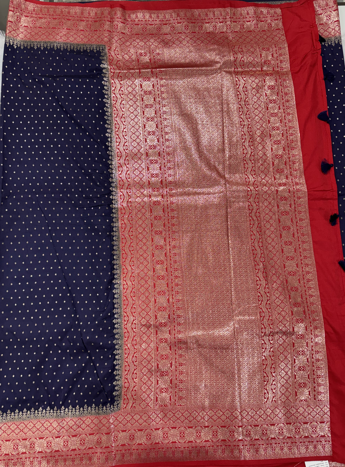 Banarasi Fancy Saree Navy Blue Colored Complemented with a Red Zari Border.