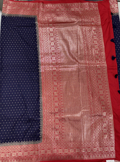 Banarasi Fancy Saree Navy Blue Colored Complemented with a Red Zari Border.