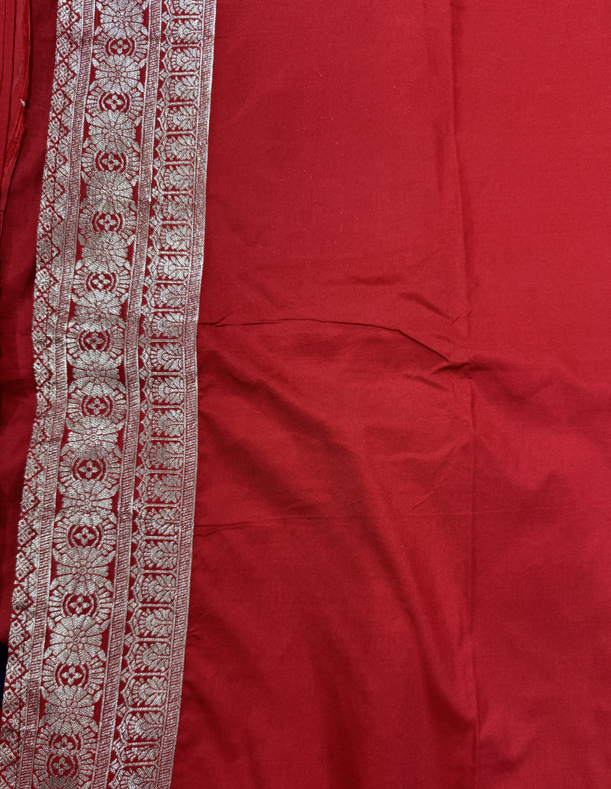 Banarasi Fancy Saree Navy Blue Colored Complemented with a Red Zari Border.