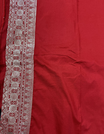 Banarasi Fancy Saree Navy Blue Colored Complemented with a Red Zari Border.