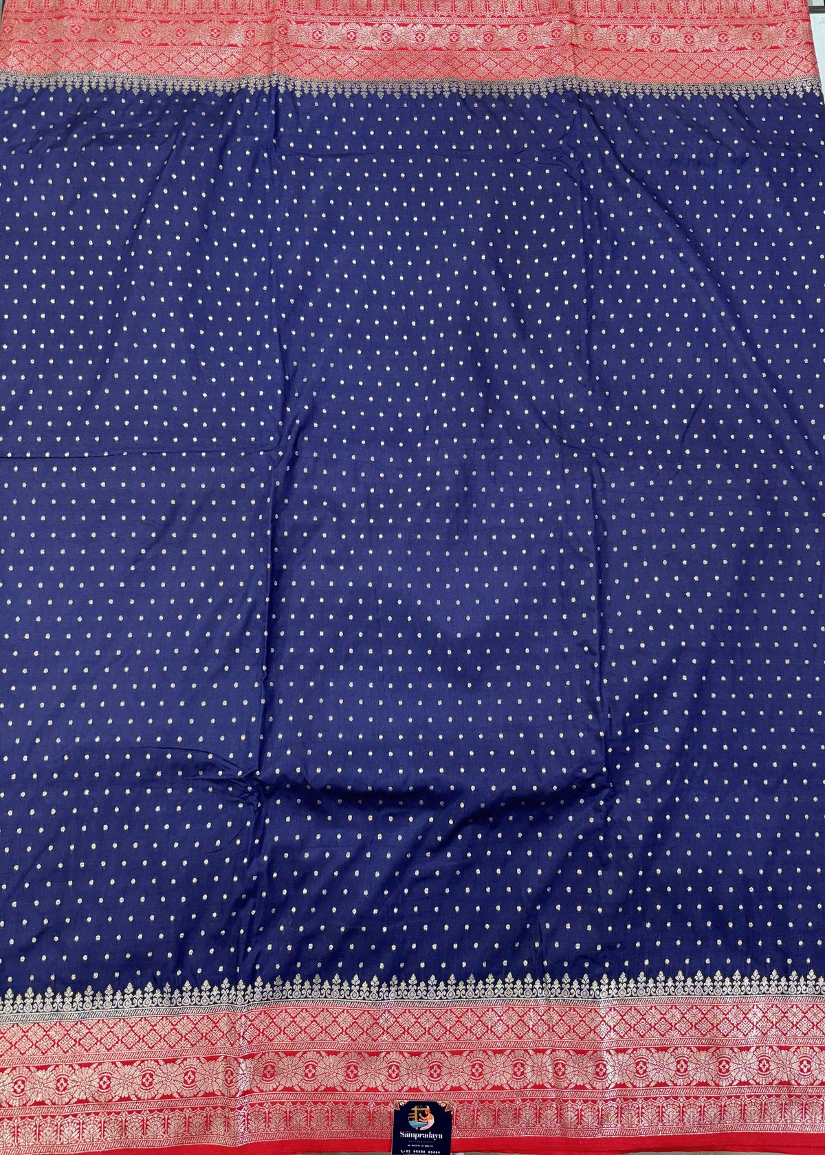 Banarasi Fancy Saree Navy Blue Colored Complemented with a Red Zari Border.