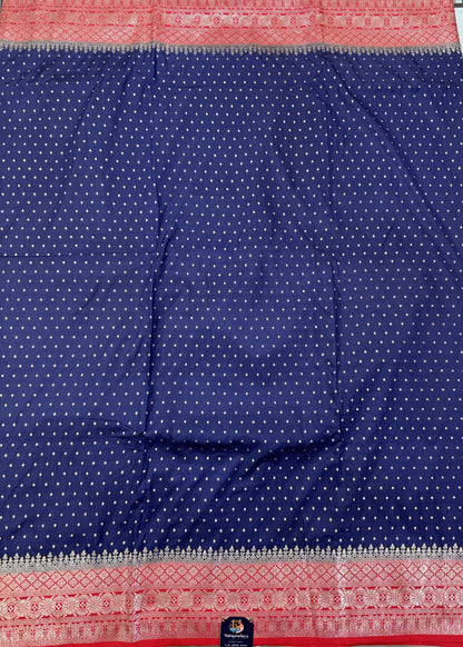 Banarasi Fancy Saree Navy Blue Colored Complemented with a Red Zari Border.
