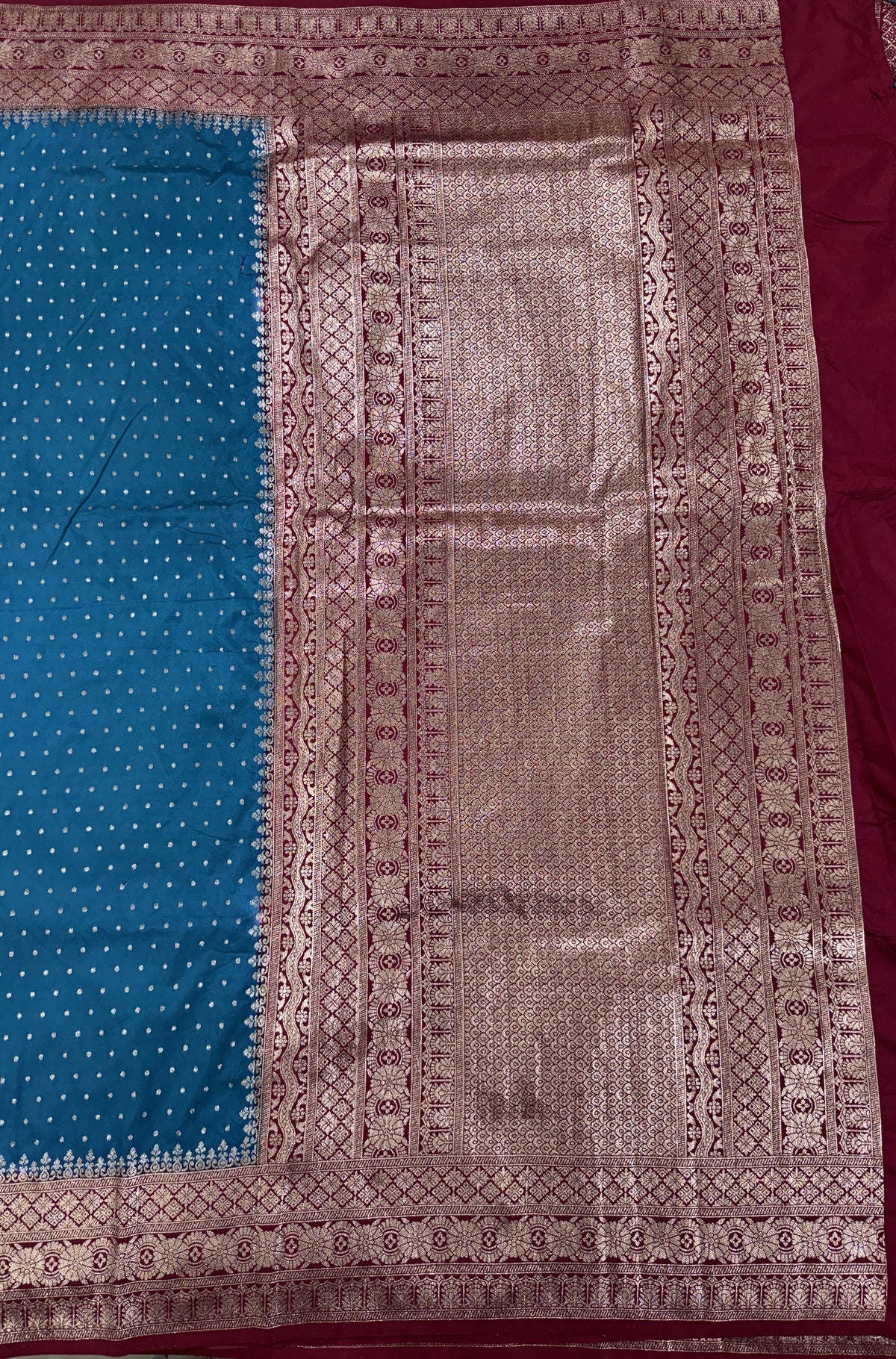 Banarasi Fancy Saree Teal Blue Colored Complemented with a Magenta Zari Border.