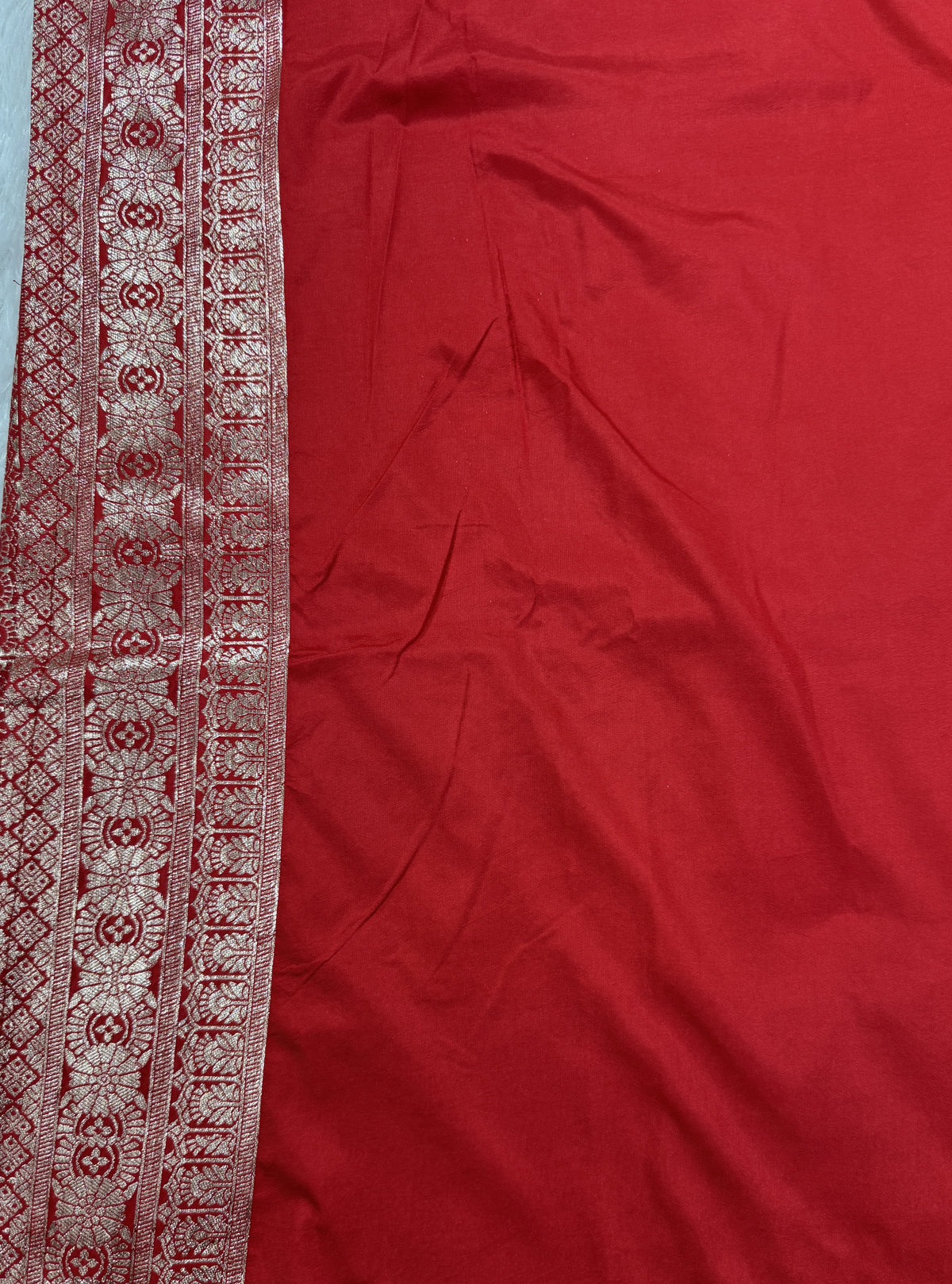 Banarasi Fancy Saree Black Colored Complemented with a Red Zari Border.