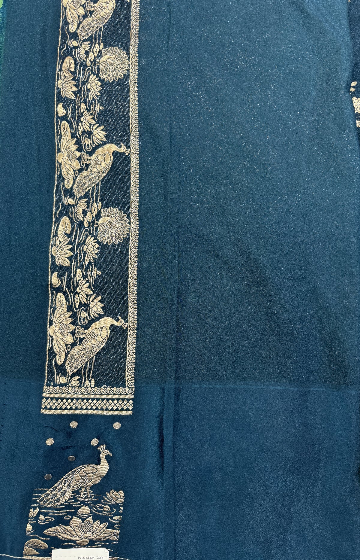 Banarasi Fancy Saree Dark Teal Blue Blue Colored Complemented with a Light Green Zari Border.