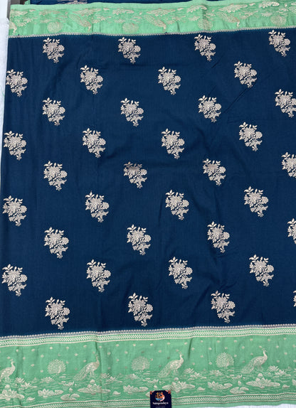 Banarasi Fancy Saree Dark Teal Blue Blue Colored Complemented with a Light Green Zari Border.