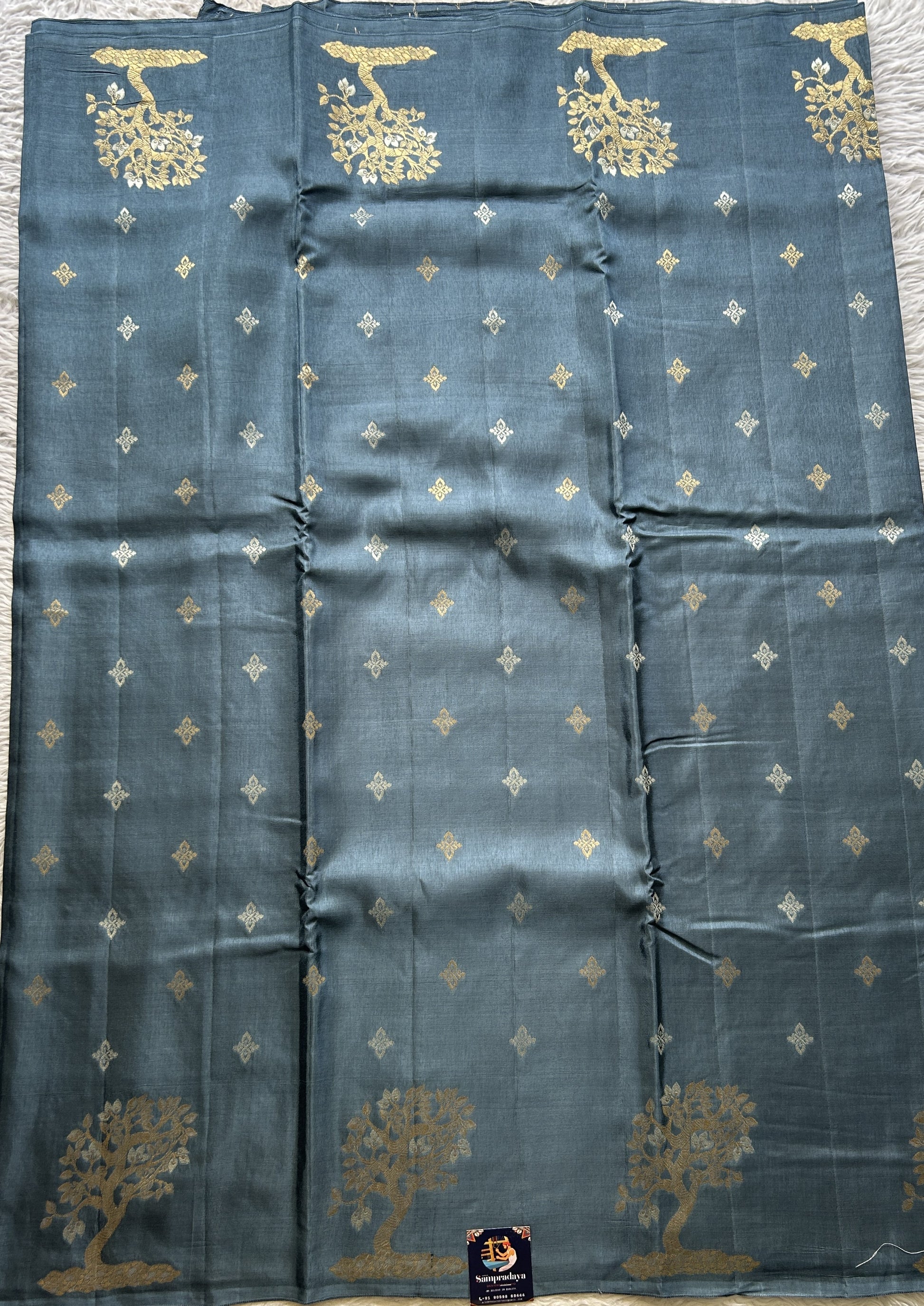 Mona Silk Saree Teal Blue Colored Complemented with a Buti Border. - Sampradaya Designer Studio