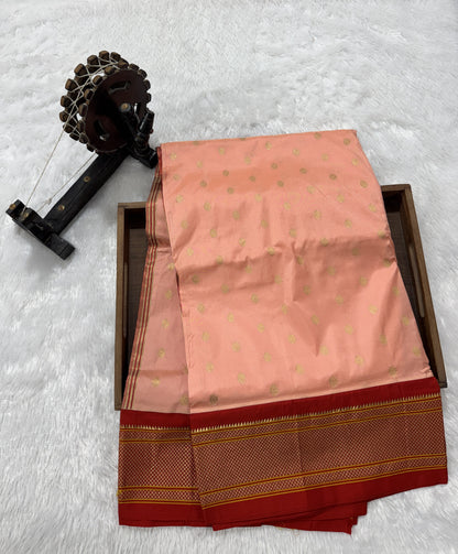 Narayanpet Silk Saree Peach Colored Complemented with a Red Zari Border.