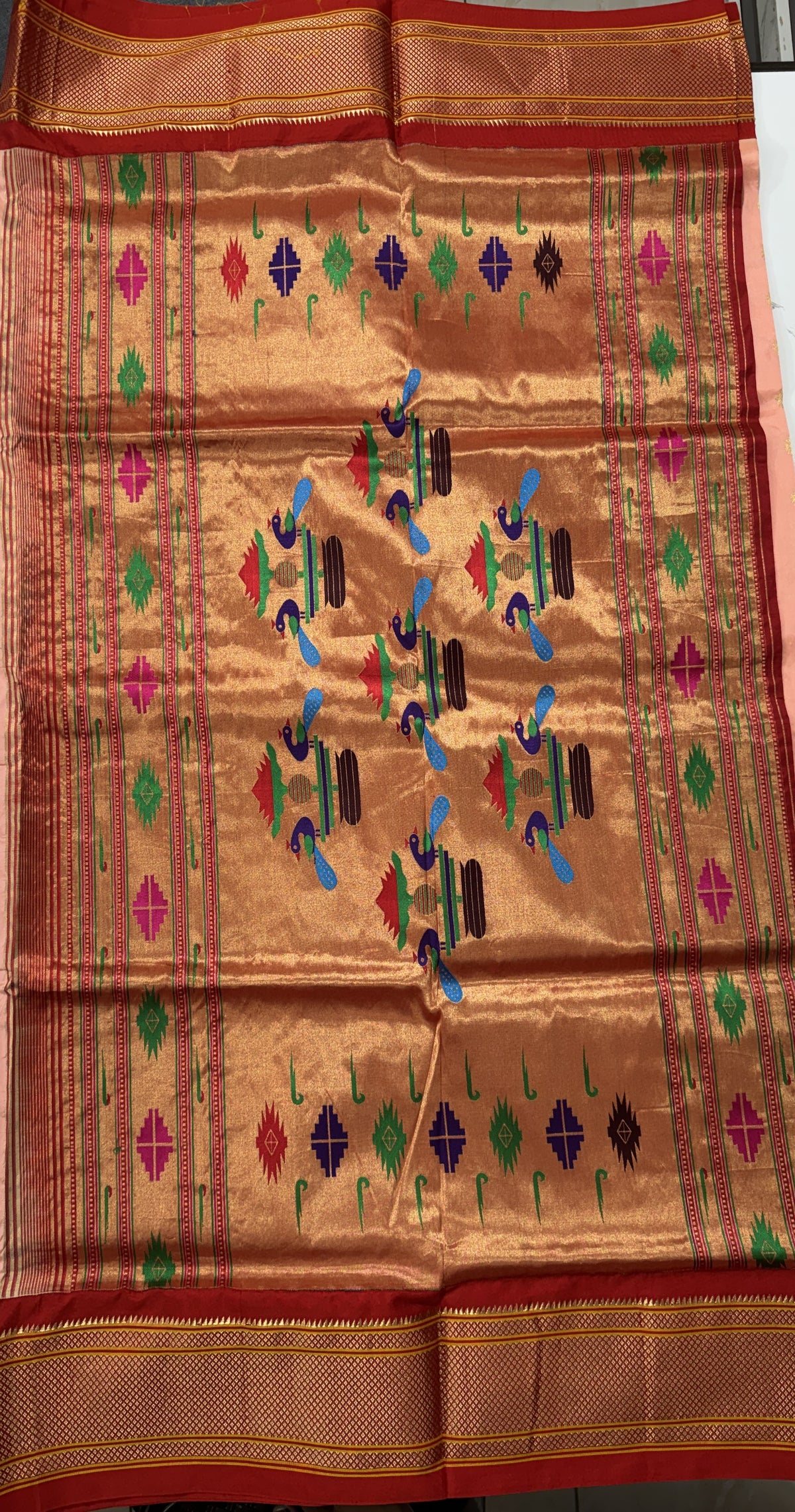 Narayanpet Silk Saree Peach Colored Complemented with a Red Zari Border.