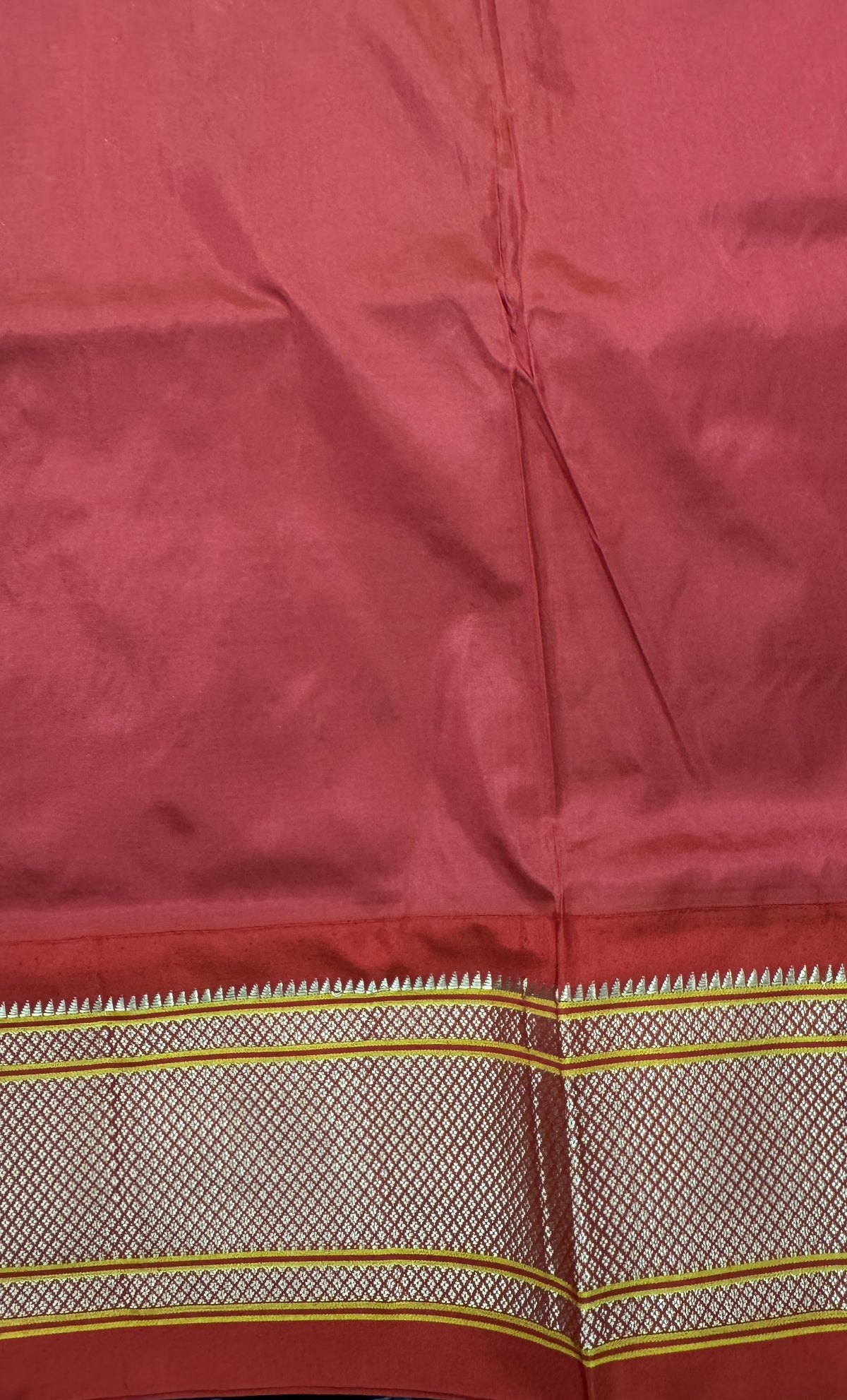 Narayanpet Silk Saree Peach Colored Complemented with a Red Zari Border.