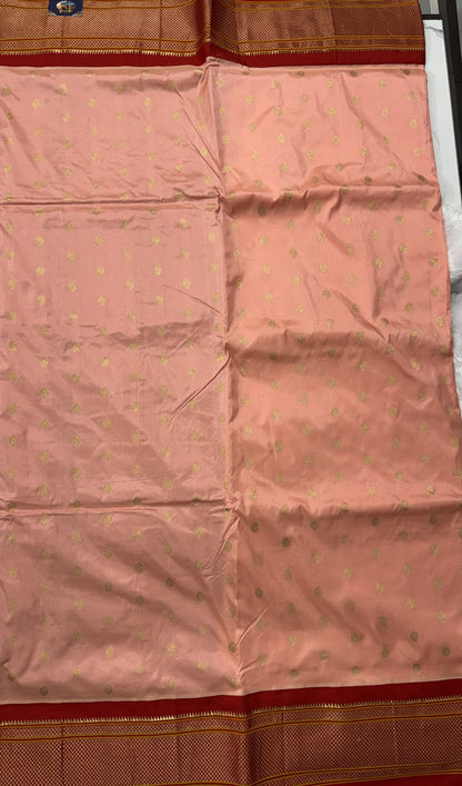 Narayanpet Silk Saree Peach Colored Complemented with a Red Zari Border.