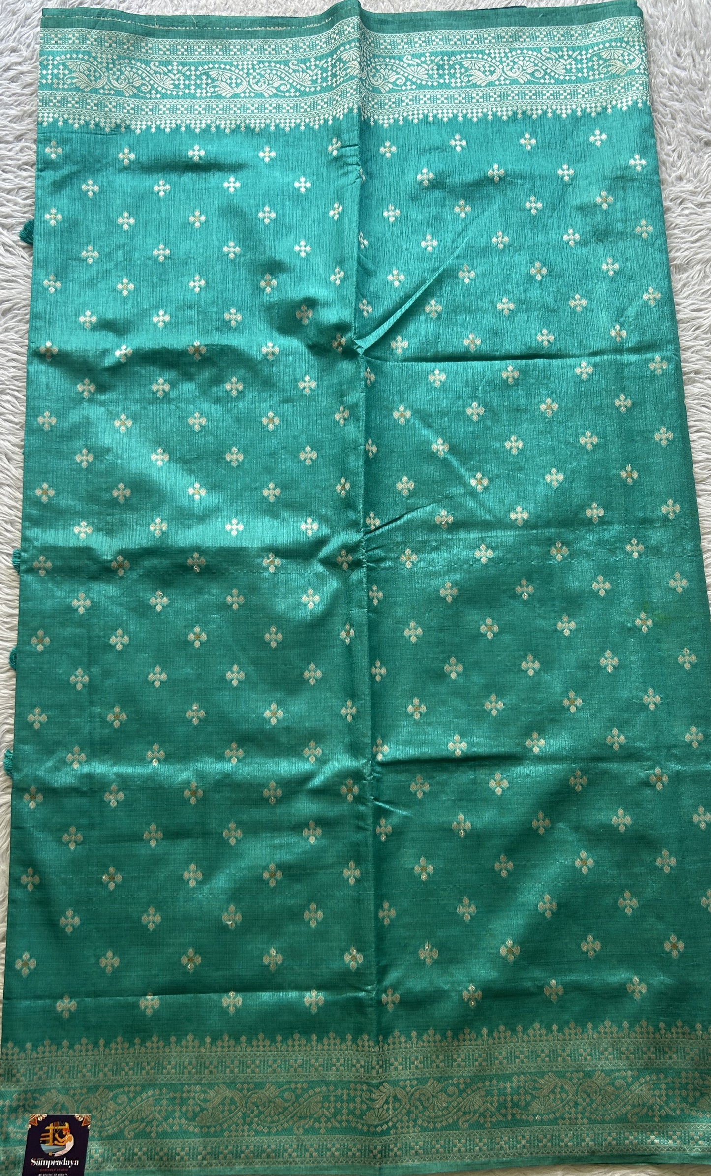 Semi Raw Silk Saree Turquoise Colored Elegantly Paired with a Zari Border. - Sampradaya Designer Studio