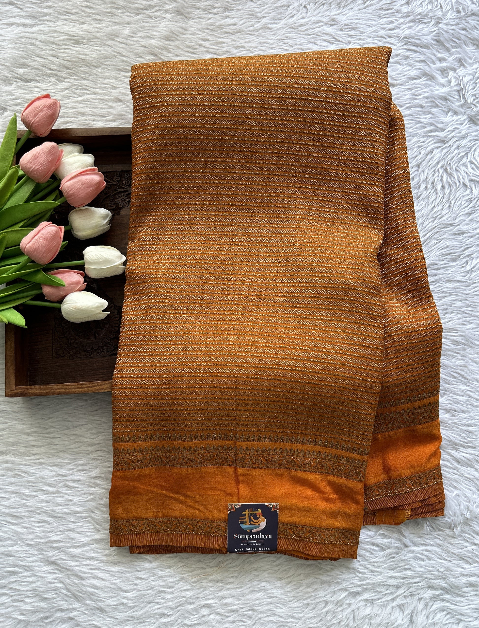 Semi Georgette Saree Orange Colored Complemented with a Zari Border. - Sampradaya Designer Studio