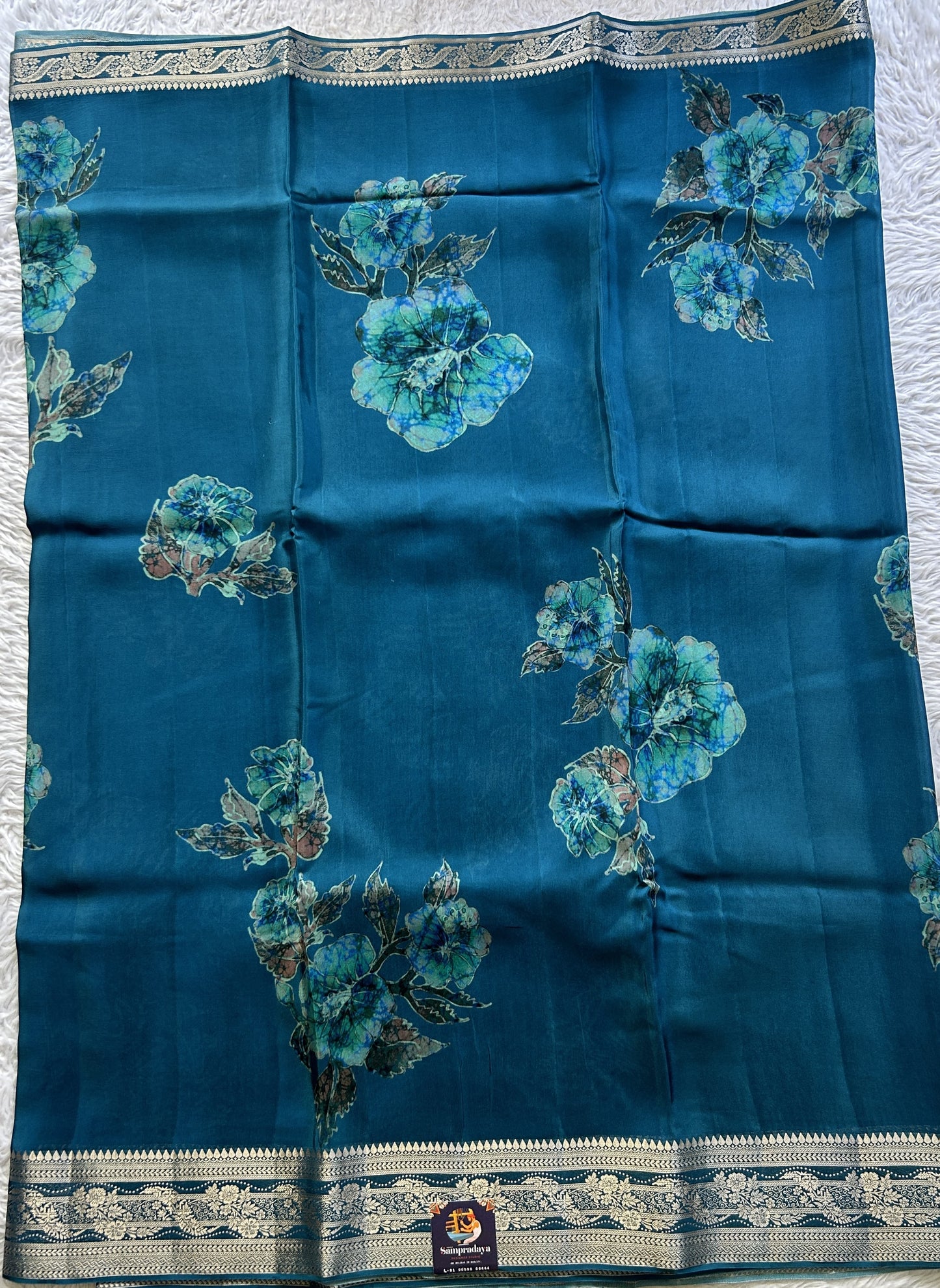 Satin Georgette Saree Peacock Blue Colored Elegantly Paired with a Zari Border. - Sampradaya Designer Studio
