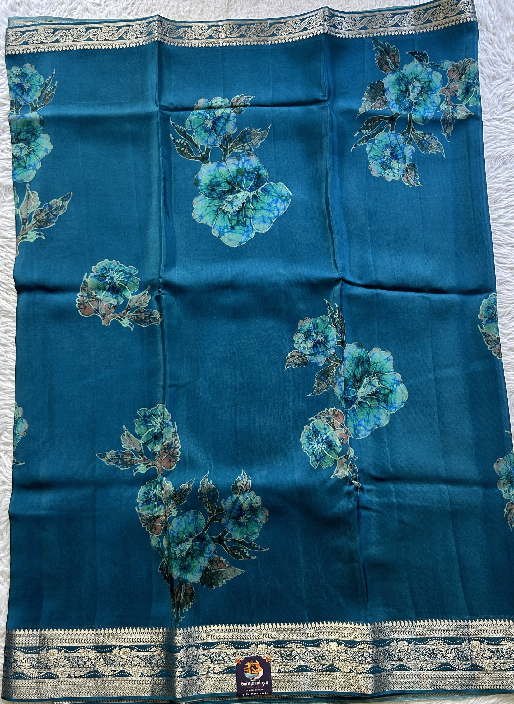 Satin Georgette Saree Peacock Blue Colored Elegantly Paired with a Zari Border. - Sampradaya Designer Studio