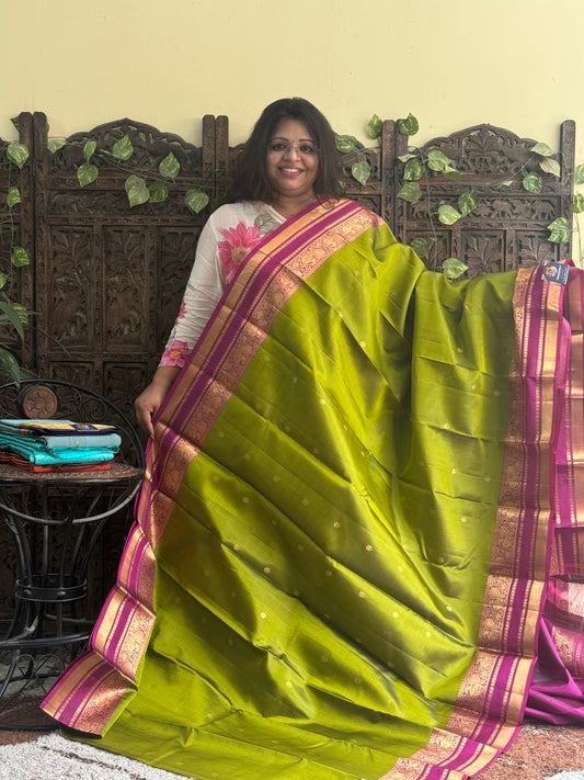 Pure Kanjivaram Silk Saree Light Mehandi Green Colored Complemented with Pink color Border with a Gold Zari Weaving. - Sampradaya Designer Studio