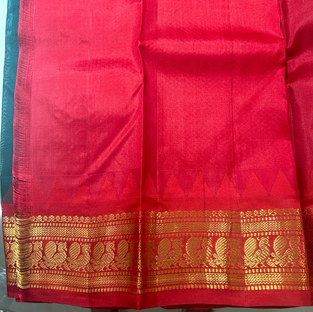 Gadwal Pattu Saree Bottle Green-colored saree complemented with a Red border - Sampradaya Designer Studio